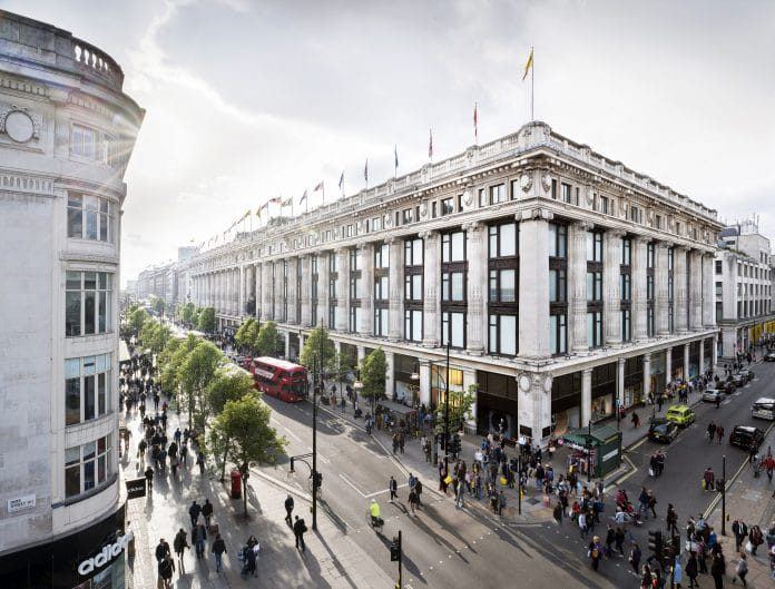 Shoppers queue outside Selfridges on Oxford Street, London before